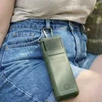 Customer photo of a MoskiCell unit clipped at the waist of a pair of denim shorts