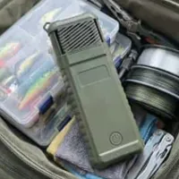 Customer photo of a MoskiCell unit lying in an open tackle bag next to lure boxes and fishing line
